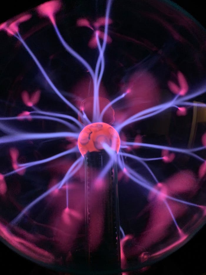 Colorful plasma globe showcasing electric filaments in mesmerizing patterns.